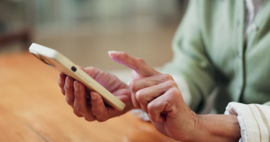 Senior, woman and hands in home with phone, typing text message and browsing internet for digital news. Old person, tech and network in house for online article, social media and app for mobile chat.