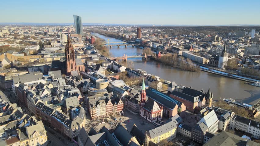 Aerial view of the historic Romerberg square, Frankfurt Cathedral, and the Main river flowing through the urban landscape of Frankfurt am Main, Hessen, Germany.
