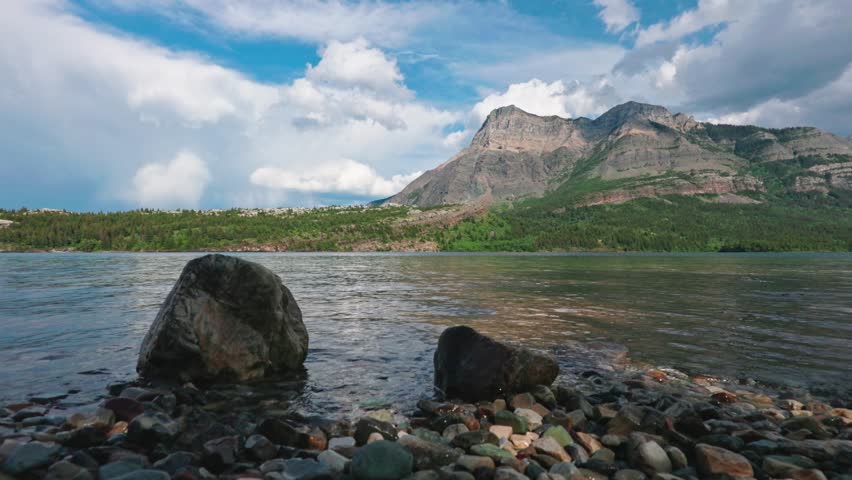 A scenic footage of the Two Medicine Lake, located in Glacier National Park, Montana, USA on a sunny day