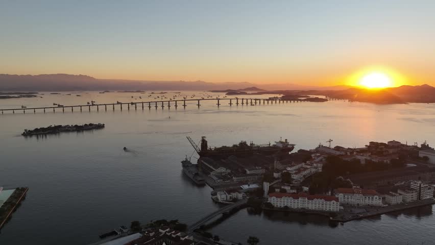 Rio de Janeiro in sunrise, Brazil. City center. Aerial view, establishing shot. Rio Niteroi Bridge.