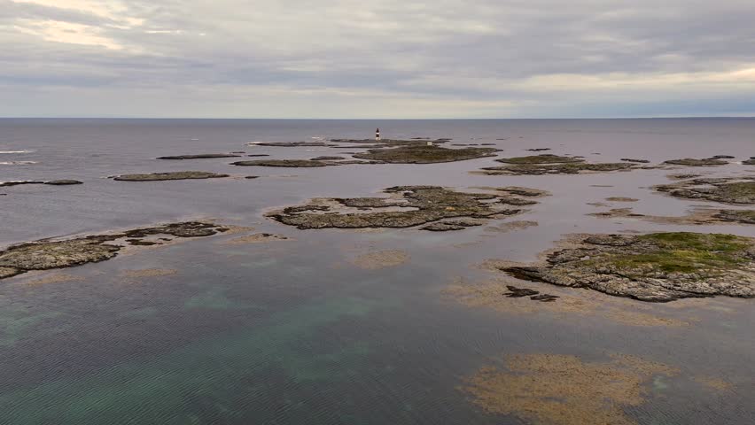 An Aerial view of Haugjegla lighthouse standing on a remote islet near Veiholmen fishing village, Smoela, Norway