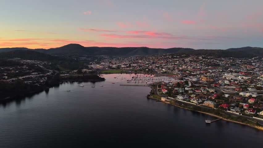 Aerial drone footage of vibrant sunset over the Derwent River and Bellerive, Hobart, Tasmania, Australia