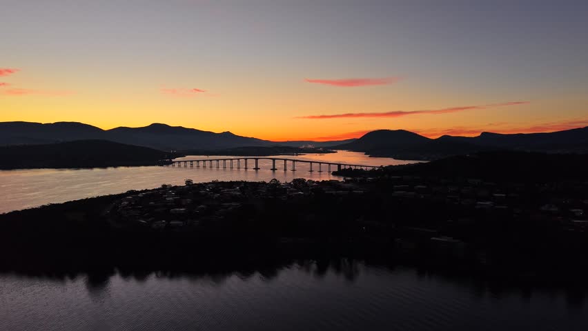 Aerial drone footage of vibrant sunset over the Derwent River and Bellerive, Hobart, Tasmania, Australia