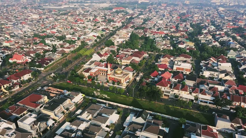 Beautiful Aerial Drone Footage of a Dense Suburban Housing Complex with a Golden Dome Mosque. Surabaya, Indonesia.