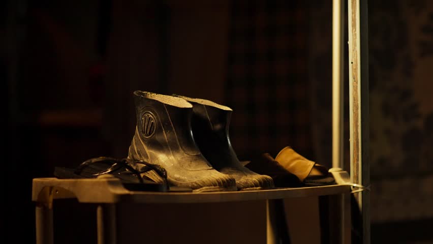 Old Leather Boots on Shoe Rack in Dark Moody Scene