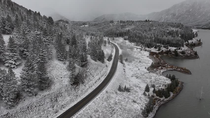 Aerial view of the snow-covered lake road in Montana, USA, showcasing the natural scenery along the route.