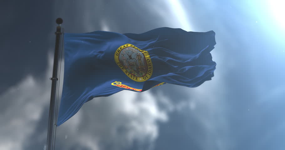 Flag of american state of Idaho waving with a cloudy sky. Loop. Slow Motion