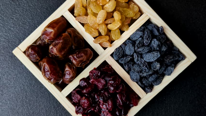 Dried fruits and berries, cranberries, dates, and raisins for a healthy diet. Dried berries and fruits as a food background for your design