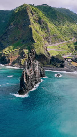 Coastal rock formations on Madeira, Portugal. Aerial footage of Atlantic shoreline with dramatic volcanic stacks and ocean waves