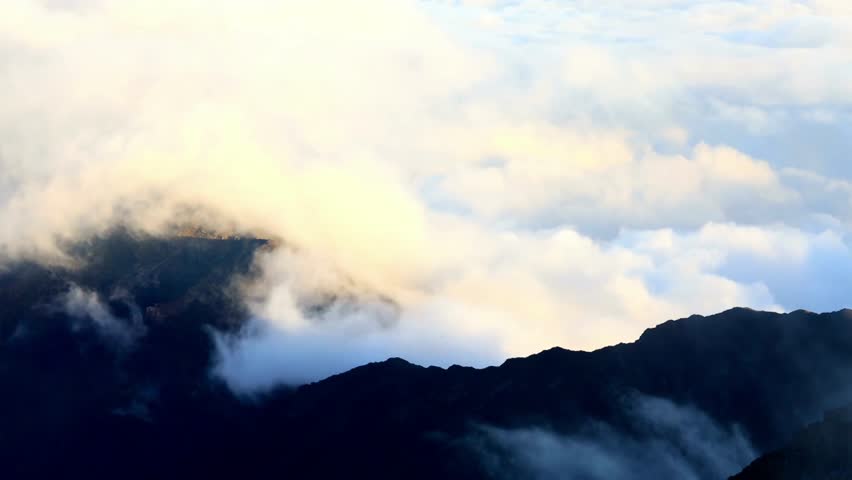 Dramatic Mountain Peaks Covered by Thick Clouds and Mist in a Scenic High Altitude Landscape