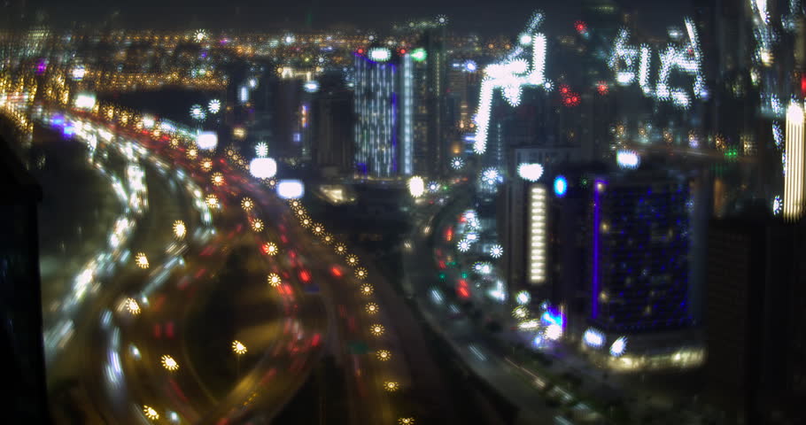 Dubai cityscape timelapse at night, towers and highway in soft focus, colorful bokeh lights, car light trails, sparkling star shaped lamps, magical atmosphere, United Arab Emirates