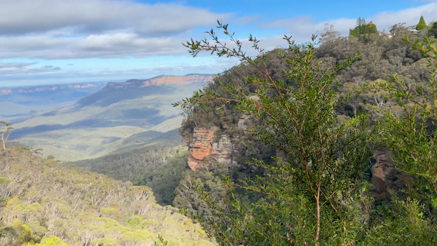 Wide shot of sandstone cliffs and eucalyptus forests in Jamison Valley, Blue Mountains, Australia.