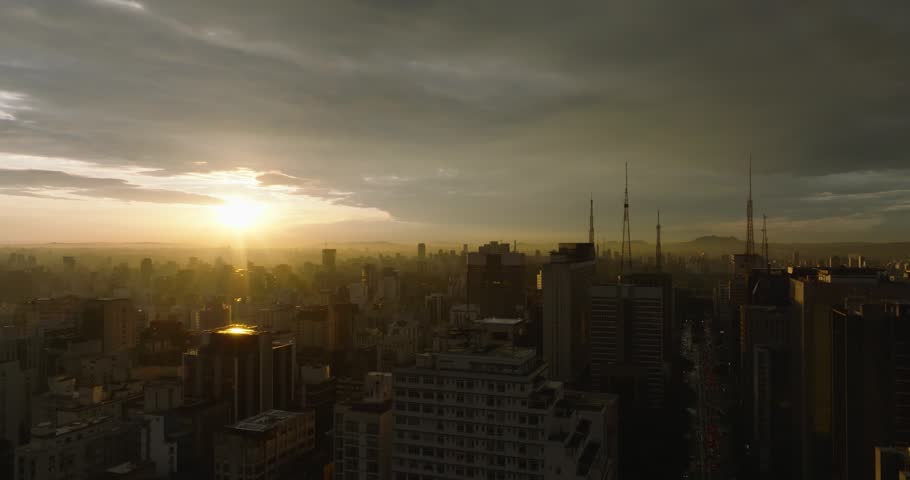 Aerial descending between skyscrapers at sunset. Sao Paulo, Brazil