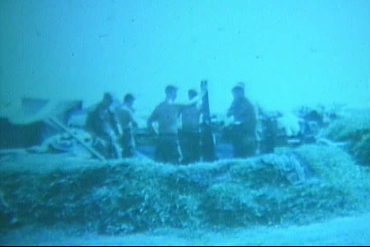 1960s - Soldiers cleaning and assembling a mortar gun in Vietnam