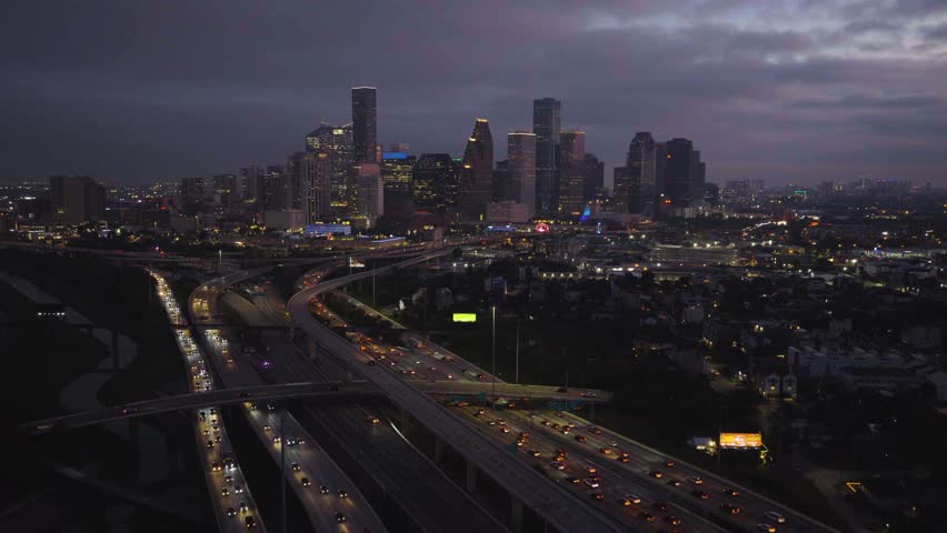 Aerial pull back shot of Houston Downtown Skyline Over I-45 Interstate, dusk