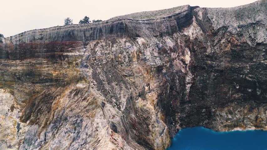 Aerial Horizon Shot Revealing Scale of Indonesian Stratovolcano Crater Lakes. Majestic Mountain Range Landscape with Sulfur Water Pools Under Soft Foggy Sky in Remote Wilderness 4k