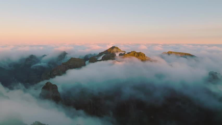Majestic Rocky Mountain Peaks Emerging Above a Sea of Clouds at Sunrise