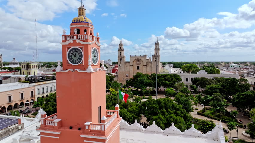 Aerial view of a tall red colonial building with a clock tower in central Merida, Yucatan, Mexico, rising above the historic city centre.