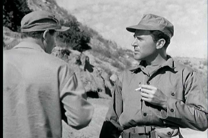 1950s - A pair of military avoid a bomb while discussing combat fatigue