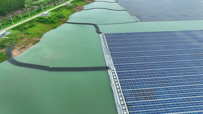 Aerial landscape of floating solar panels across a water reservoir, symbolizing energy innovation, climate solutions, and the global transition toward clean and sustainable power systems. 4k.
