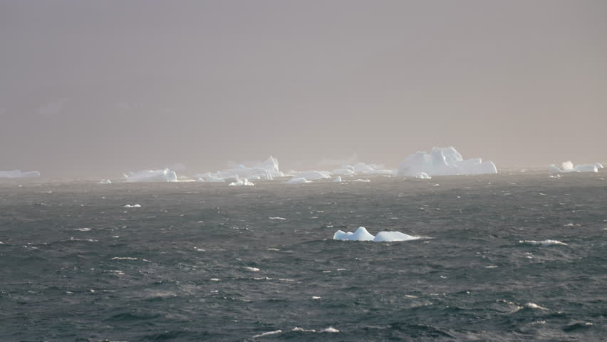 Small Icebergs in Ocean Water on Misty Day, Slow Motion