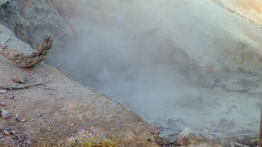 Steaming geothermal mud pot with bubbling volcanic activity in Lassen Volcanic National Park, California, USA, with sulfuric steam rising from natural hydrothermal basin and mineral rich terrain