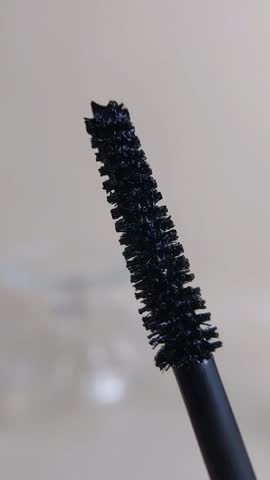 Close up of mascara brush for eyelashes. Beauty applicator tool, bristle texture for eye makeup.