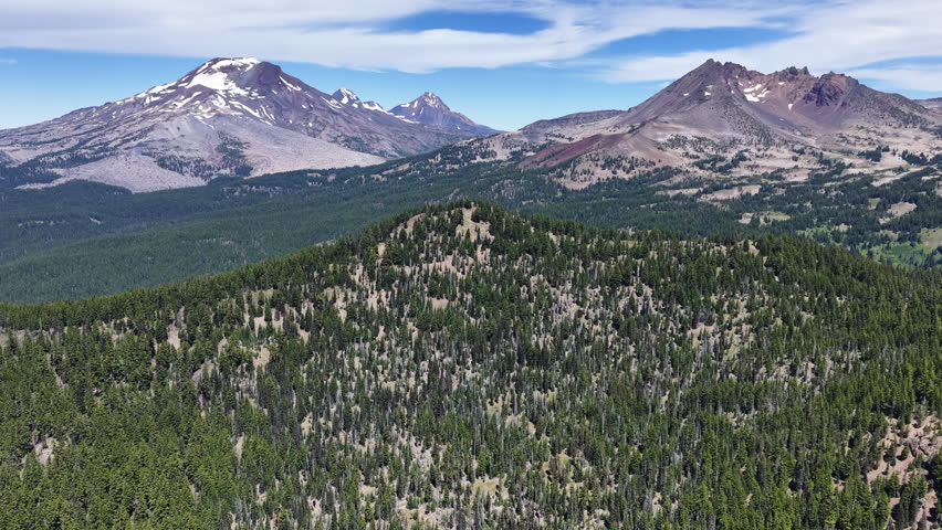 Rugged, volcanic mountains rise from the Three Sisters Wilderness in Oregon. These scenic mountains are part of the Cascade Range and just 22 miles from Bend.