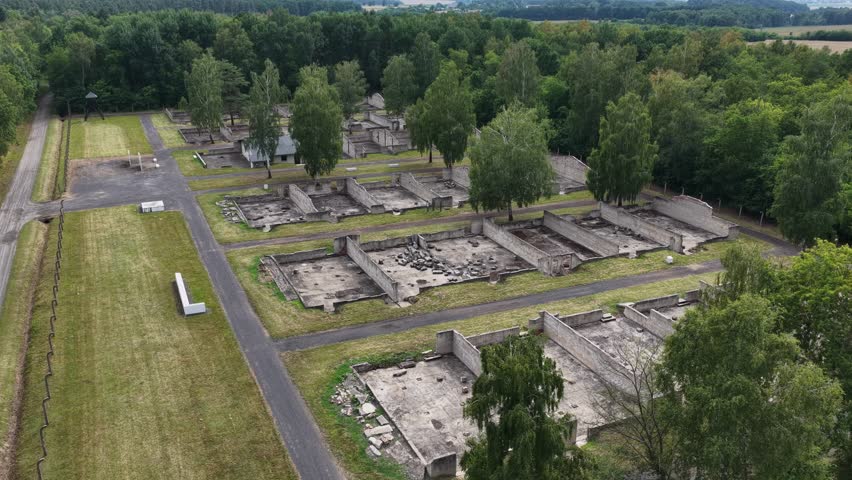 Aerial drone view of the Central Museum of Prisoners of War in Lambinowice, Poland, showing historic buildings and former Stalag 344 Lamsdorf camp grounds with preserved wartime heritage landscape.