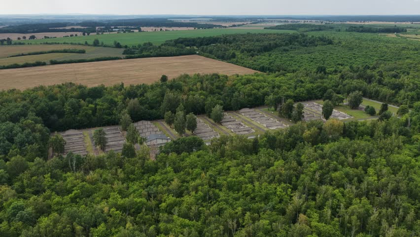 Aerial drone view of the Central Museum of Prisoners of War in Lambinowice, Poland, showing historic buildings and former Stalag 344 Lamsdorf camp grounds with preserved wartime heritage landscape.