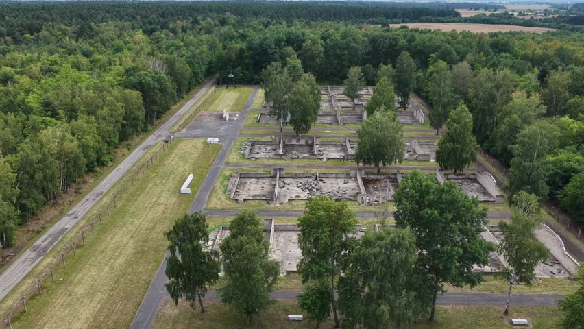 Aerial drone view of the Central Museum of Prisoners of War in Lambinowice, Poland, showing historic buildings and former Stalag 344 Lamsdorf camp grounds with preserved wartime heritage landscape.
