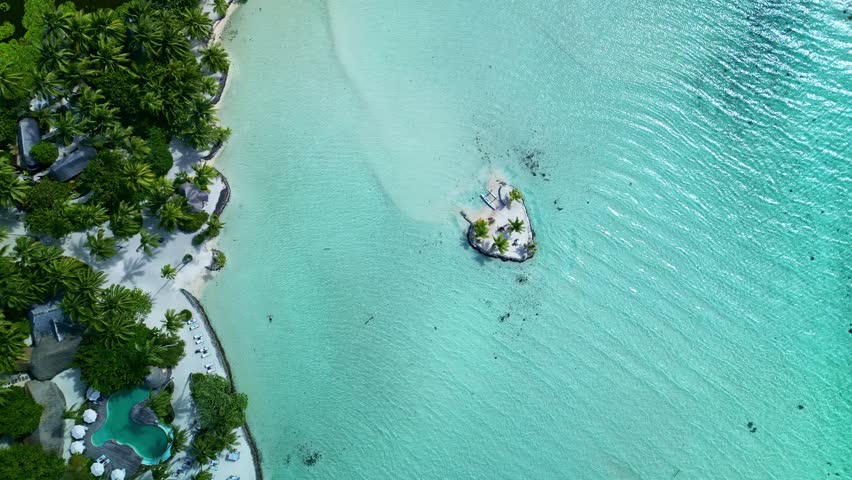 Tahaa island , french polinesia amazing aerial view of a tropical hotel, a beautiful beach and a heart shaped island in a turquoise lagoon