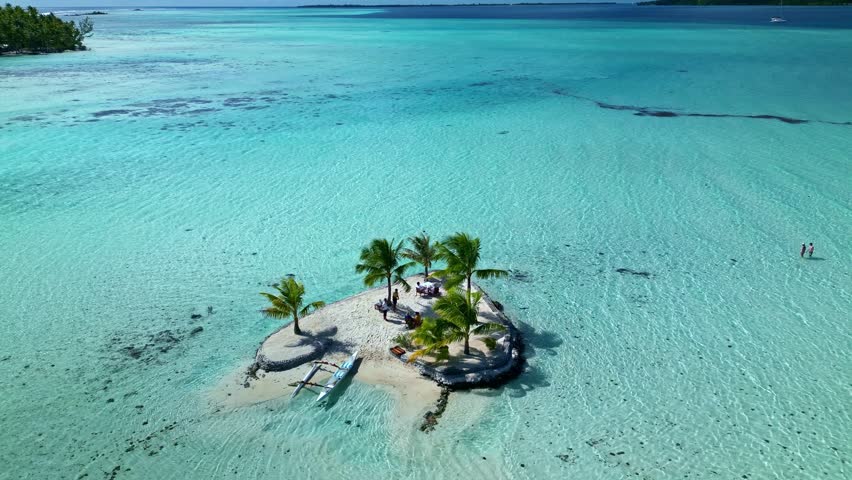 Tahaa island , french polinesia aerial view of a small private island with palm trees in a turquoise lagoon in french polynesia