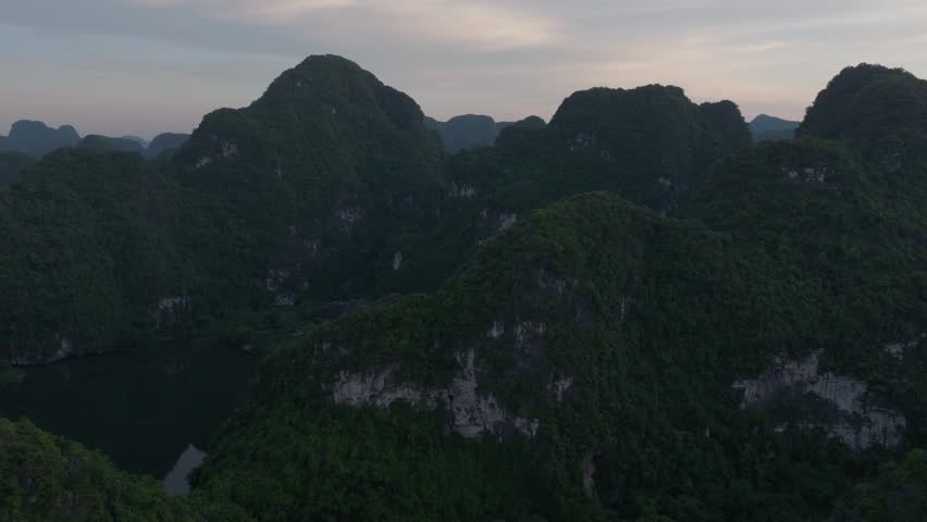 Aerial view of a tranquil mountain lake surrounded by lush greenery in Vietnam