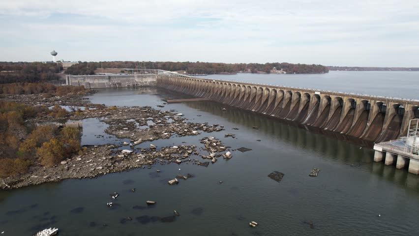 An Aerial view of Wilson Dam stretching across the Tennessee River beside rocky shallows