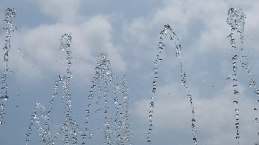 Upper Fountain Jets Spraying in Arcs Against a Cloudy Sky