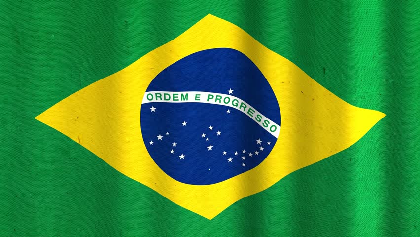 A vibrant green, yellow, and blue Brazilian flag waves with rhythmic motion, showcasing its iconic globe and starry emblem.