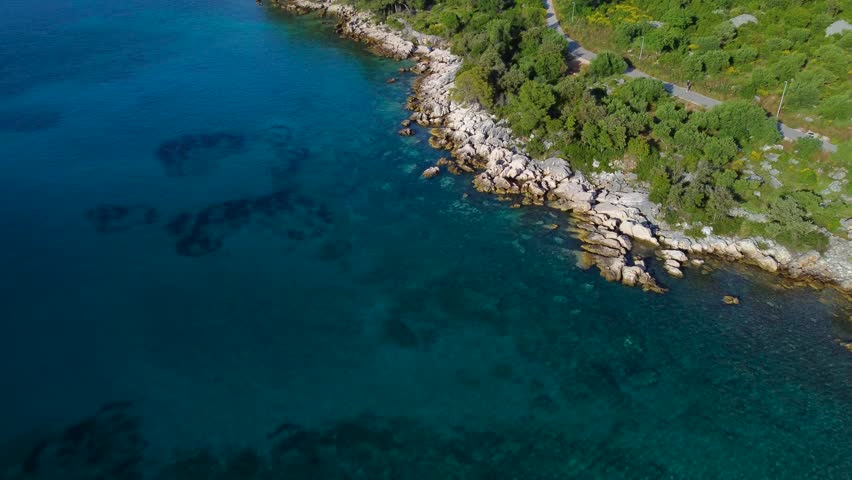 Aerial view of the beautiful croatian rocky coastline on hvar island. Turquoise adriatic sea water meeting the green mediterranean forest