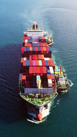 Vertical. Aerial view of container cargo ship in sea.
