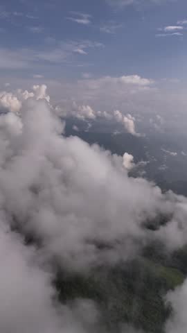 Aerial footage of a Darjeeling mountainside disappearing into thick white monsoon cloud cover