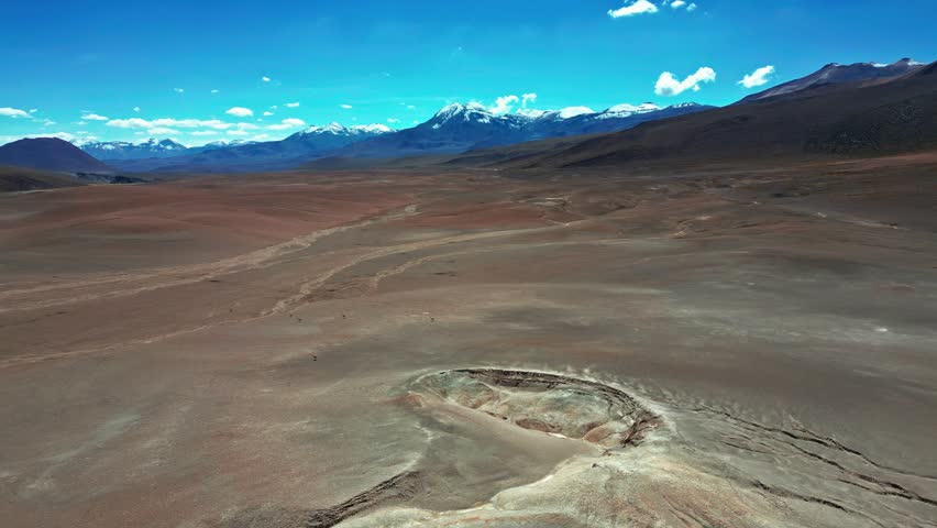 Aerial view of the arid landscape and a geological crater in the Atacama Desert, Antofagasta, Antofagasta, Chile.