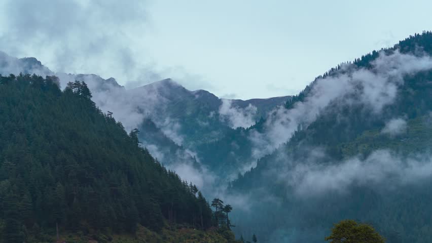  Timelapse of dark clouds moving around mountains during monsoon season at Manali, Himachal Pradesh, India. Rainy days in Himalayas. Clouds in the mountains. Nature landscape.