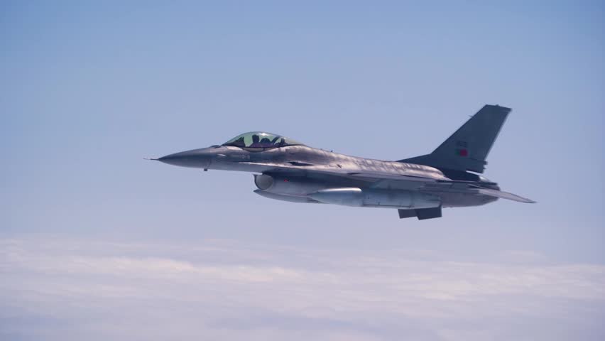 F-16 Fighting Falcon Performs High Altitude Air Patrol Mission Above Cloud Layers Under Clear Daytime Skies.