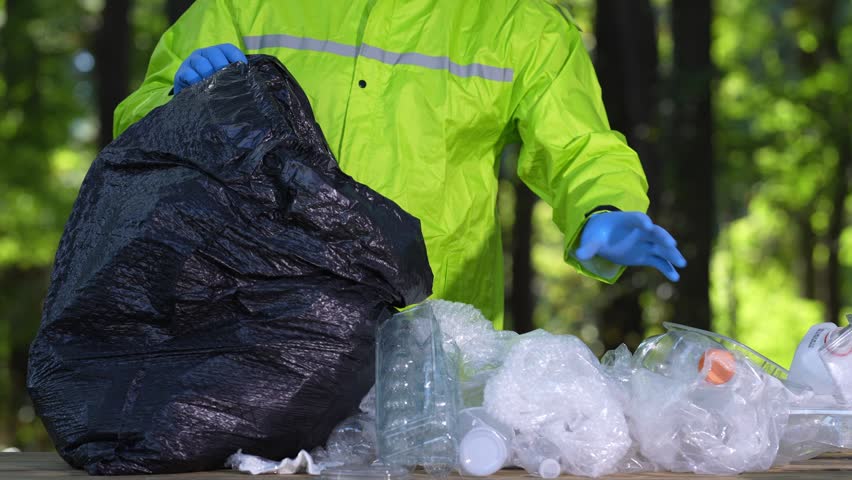 Volunteers clean parks from waste. Hands pick up plastic bottles to protect the planet. Global pollution. Plastic litter harms the environment. Rubbish cleanup. Bag of trash and eco actions. Pollution