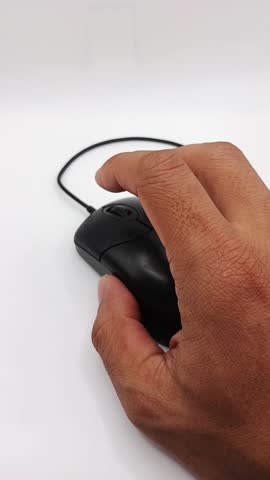 Close-up footage of a hand pressing and clicking a computer mouse. Suitable for technology, office, business, internet, and productivity concepts.