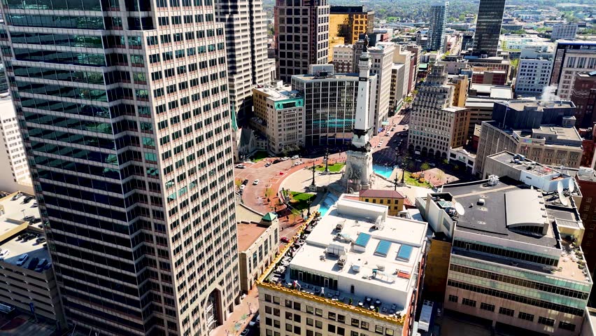 Drone footage revealing the impressive skyline of Indianapolis, Indiana, USA, with modern office towers, urban architecture, busy streets, and the dynamic atmosphere of one of the Midwest