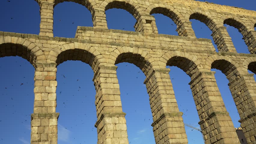 Detailed perspective of the massive granite pillars of the Roman Aqueduct of Segovia