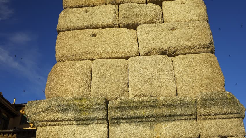 Close architectural detail of a granite pillar beneath the Roman Aqueduct of Segovia