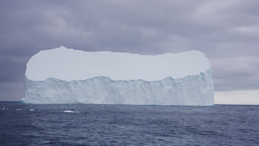 Massive tabular iceberg floating in open ocean