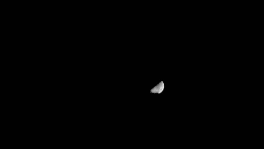 time lapse view of the half moon in the dark night sky
